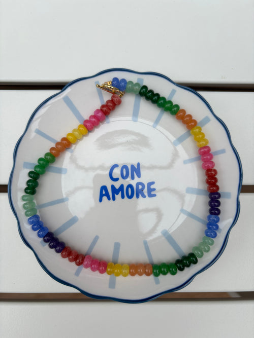 Decorative plate with colorful beads and 'CON AMORE' text on a white background