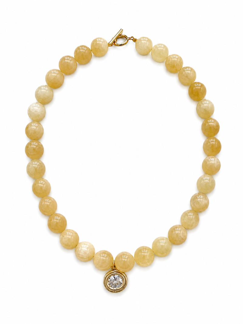 Pearl necklace with a gold clasp and diamond charm on a white background – handmade beaded jewelry by EmJ Jewels