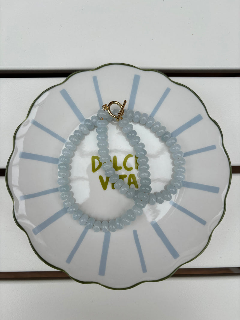 blue beaded necklace on a decorative plate with 'Dolce Vita' text. – handmade beaded jewelry by EmJ Jewels